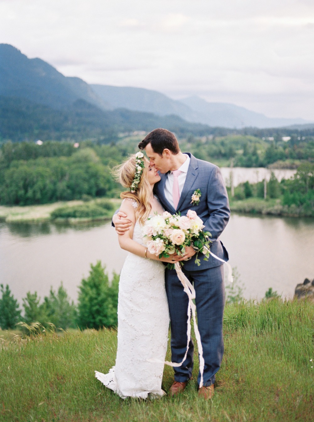 Bride and groom kissing at outdoor mountain wedding