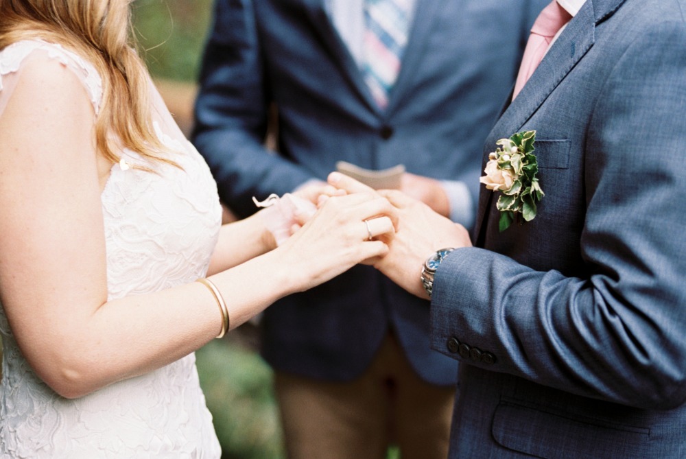 Bride and groom exchange rings at their wedding ceremony