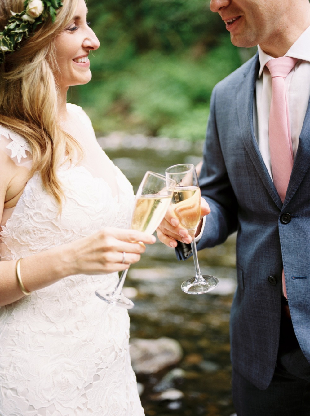 Happy bride and groom toasting with champagne