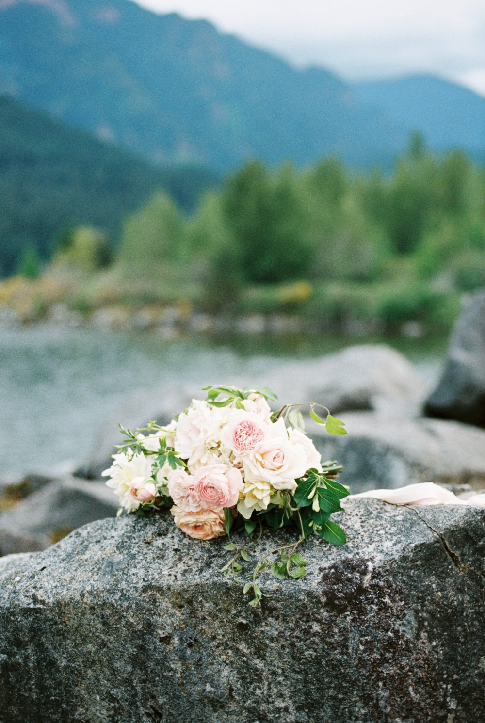 Romantic pink and white bridal bouquet on rock