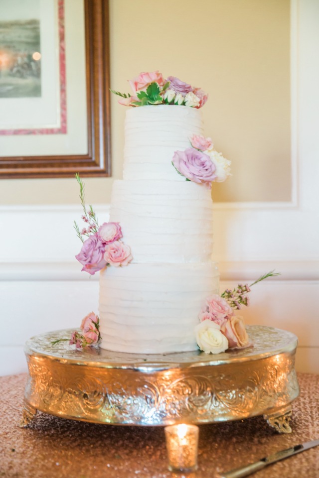 wedding cake accented with fresh flowers