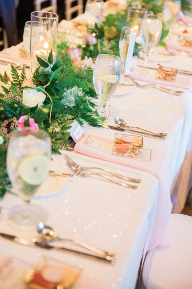 family style seating with floral garland centerpiece