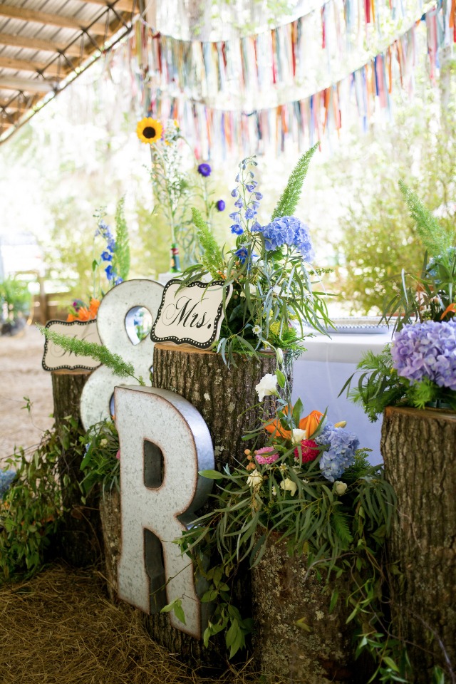 hand sawn stumps and colorful floral reception decor