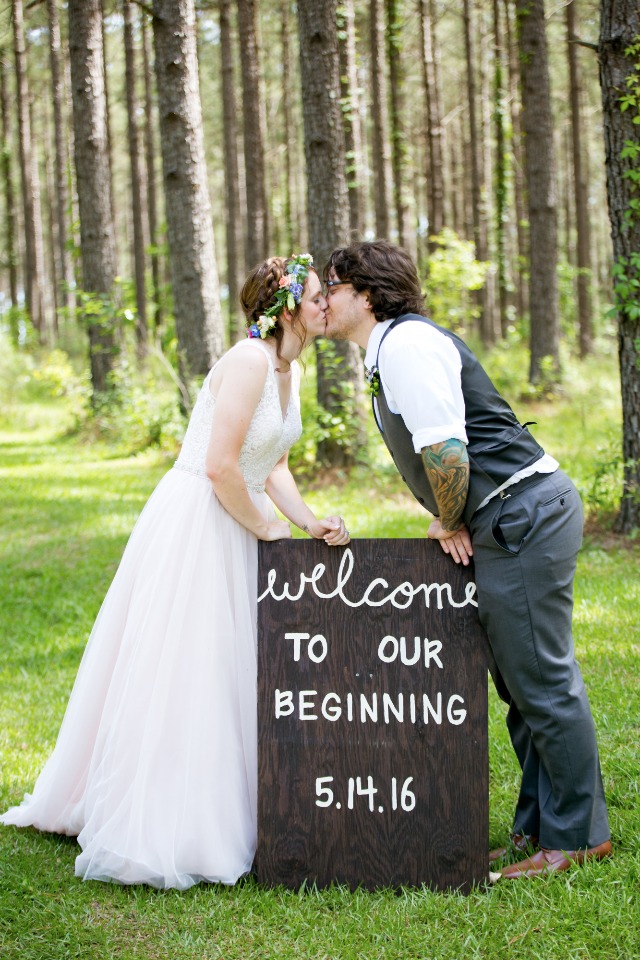 wedding kiss and super cute wedding sign