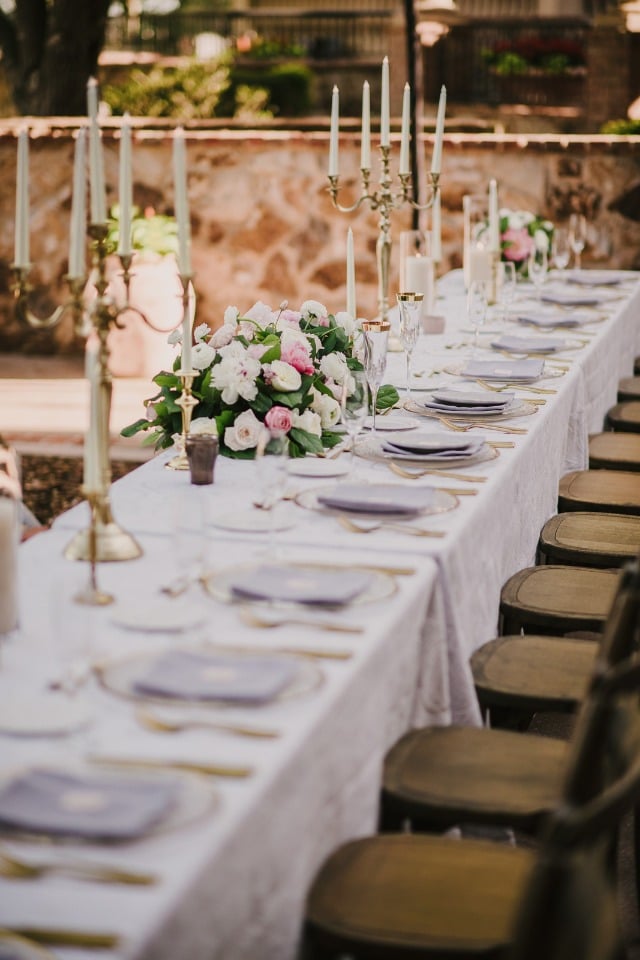 candle lined wedding table in glamorous family style seating