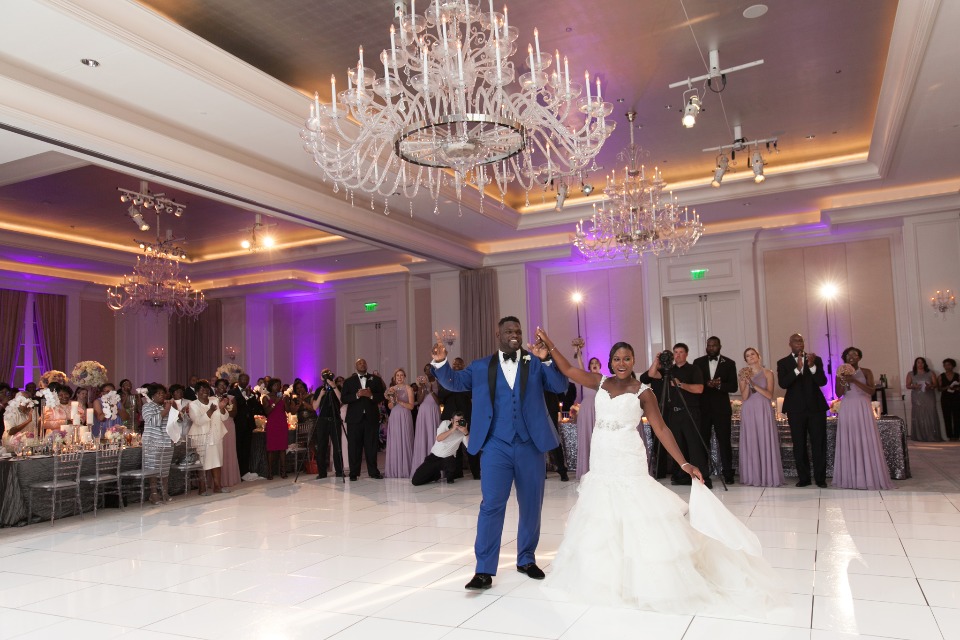 Newlyweds joyfully dance at their grand wedding reception