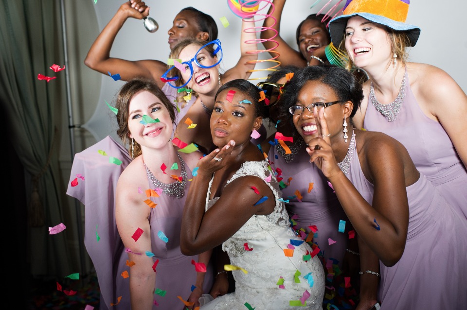 Bride and bridesmaids celebrating with confetti shower