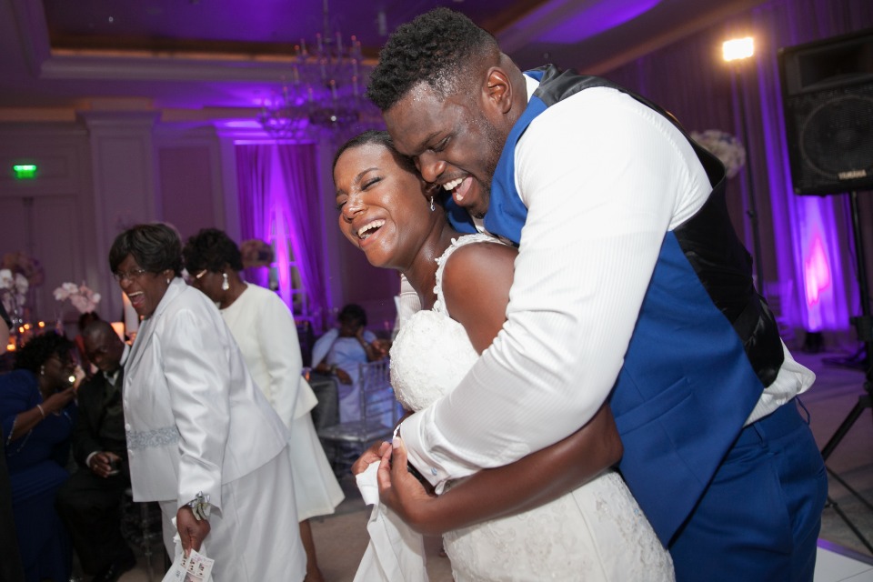 Bride and groom laughing during their wedding reception
