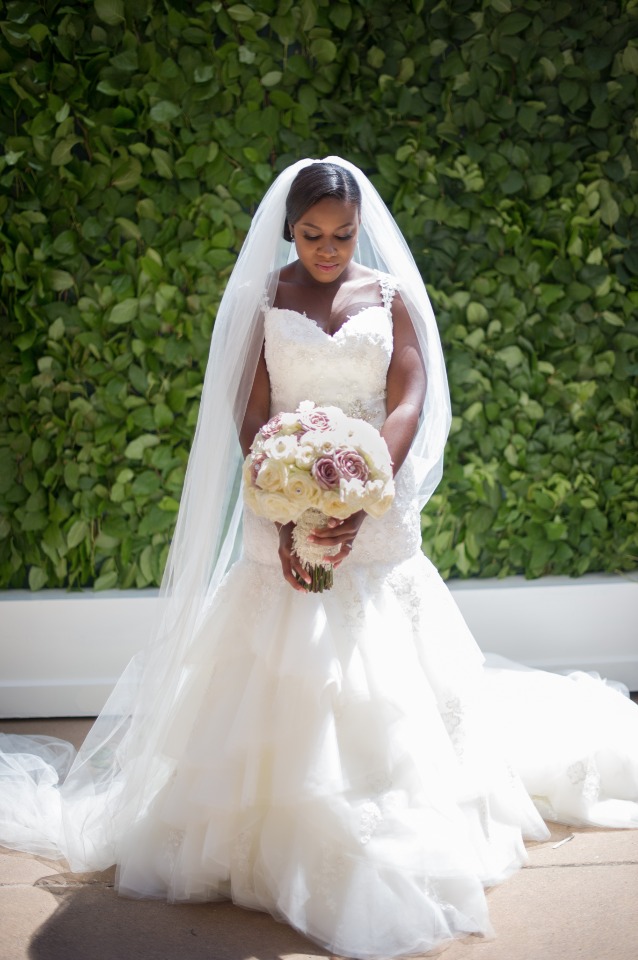 Beautiful bride with a bouquet of flowers in a white dress