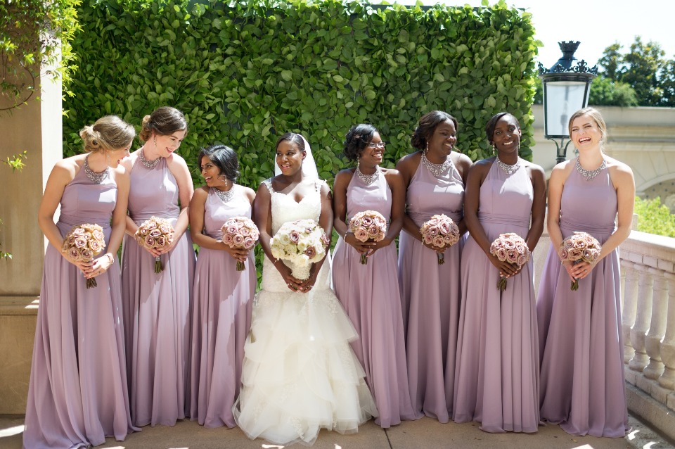 Bride and bridesmaids in lavender dresses at wedding
