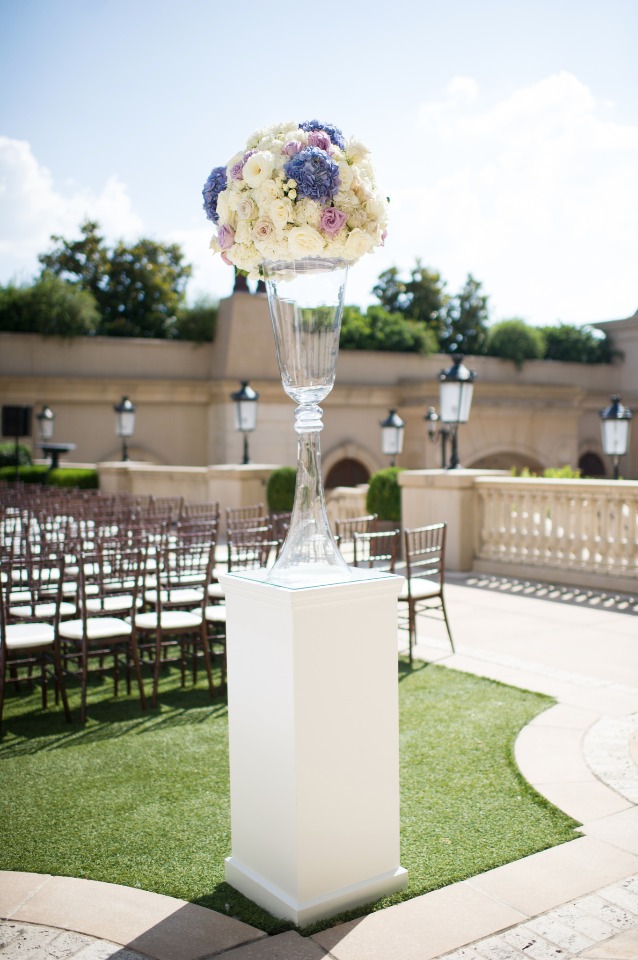Elegant floral arrangement at an outdoor wedding venue