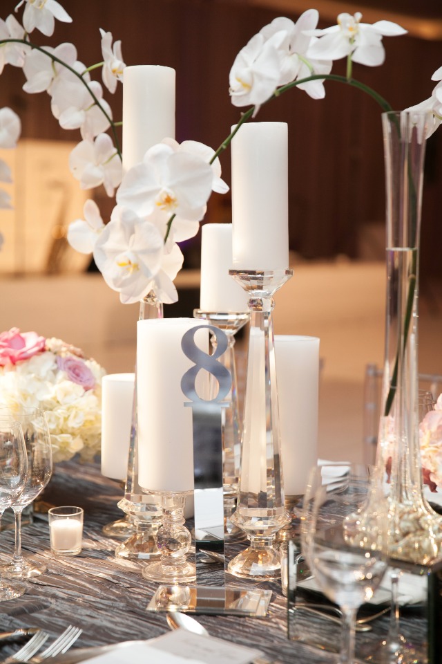 silver table number and orchid and candle centerpiece