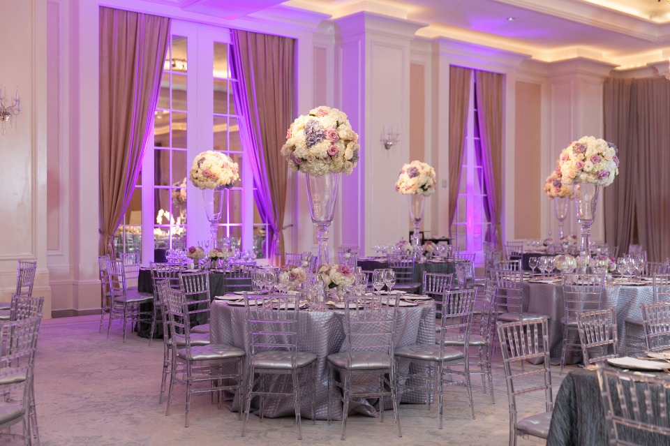 Elegant ballroom wedding reception with purple lighting