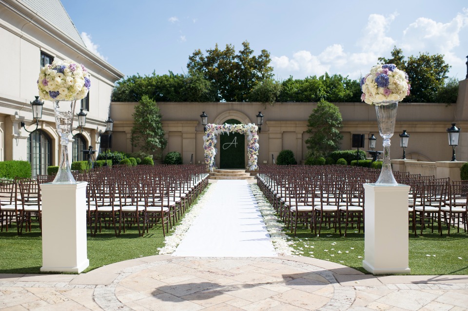 Outdoor wedding ceremony with floral arch and aisle