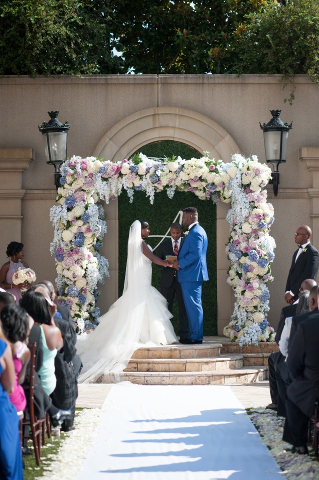 Bride and groom exchanging vows at outdoor wedding ceremony