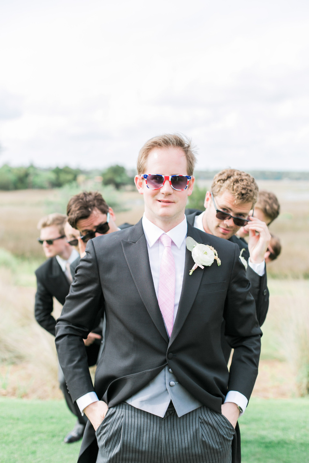 stylish black and pink groomsmen with brit sunglasses
