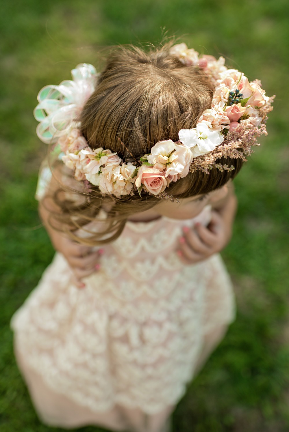 Little girl wearing flower crown and lace dress