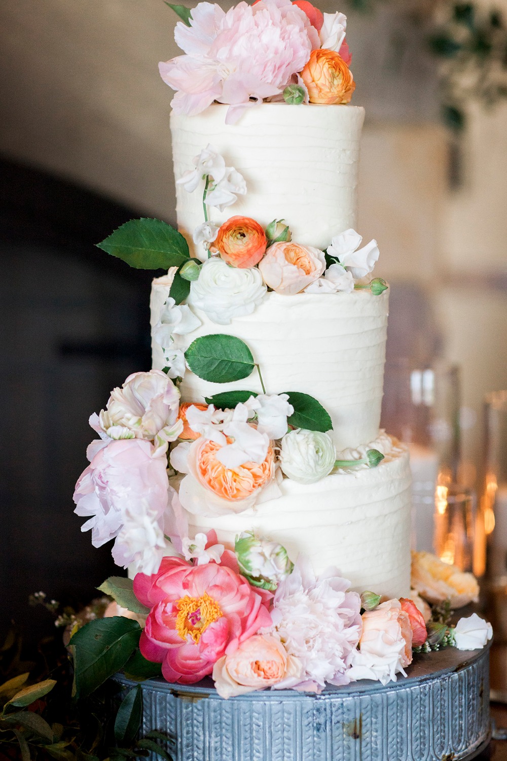 Three-tier wedding cake with cascading florals