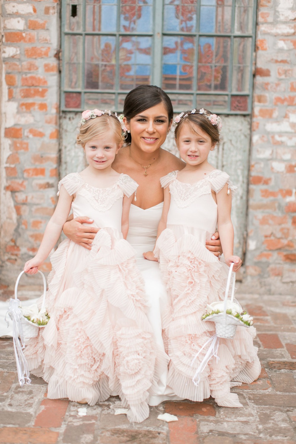 sweet little flower girls in blush pink ruffled dresses