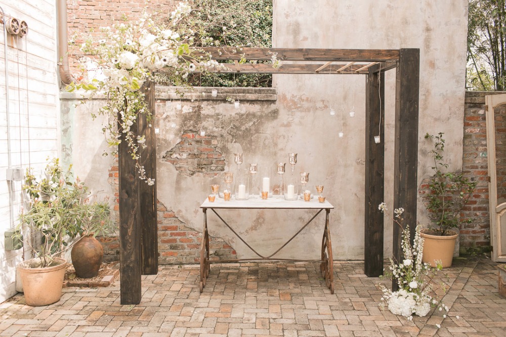 modern industrial wedding arbor accented with cascading flowers