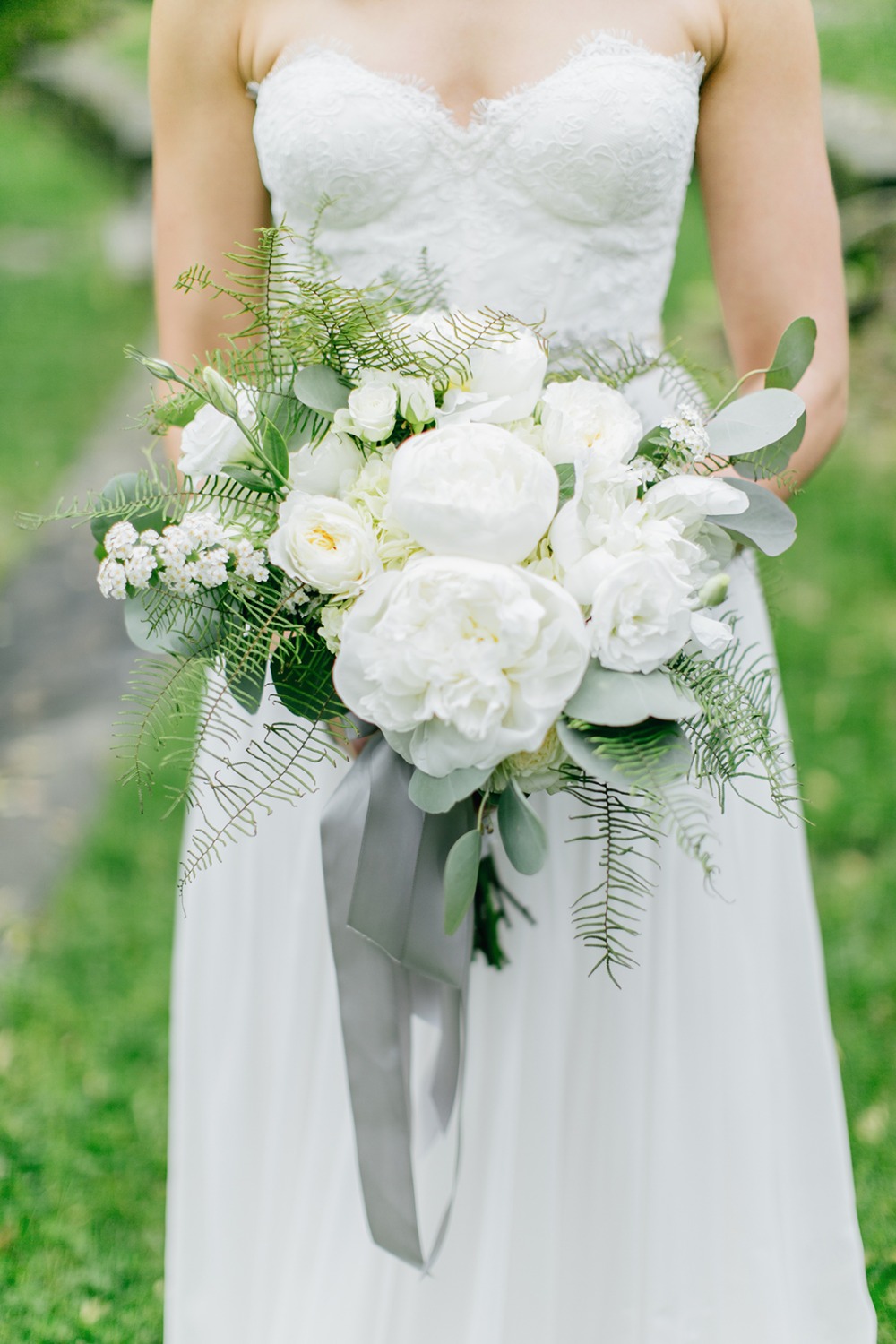 White and green wedding bouquet with gray ribbon