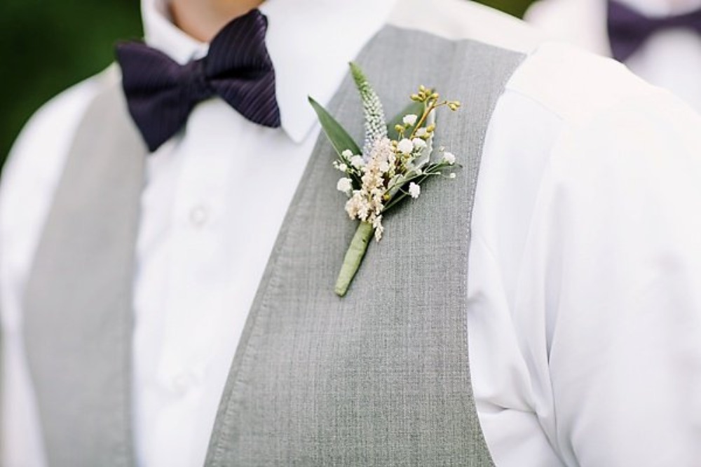 groom boutonniere in white and green