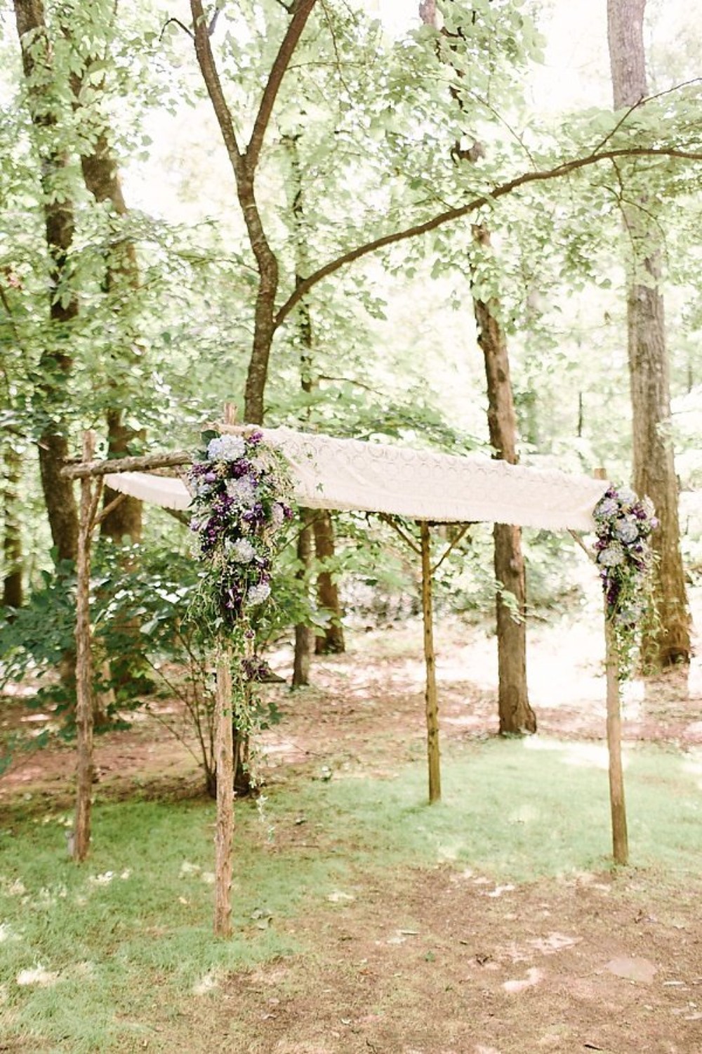 wedding arbor with purple flower accents