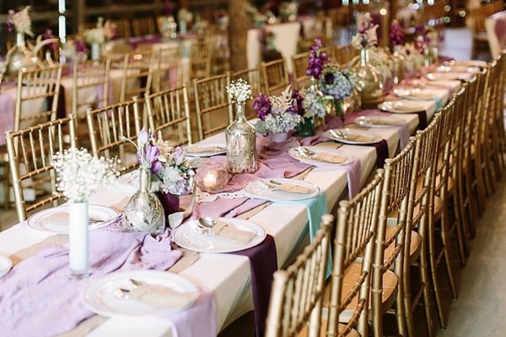 long family style seating with purple and blue decor