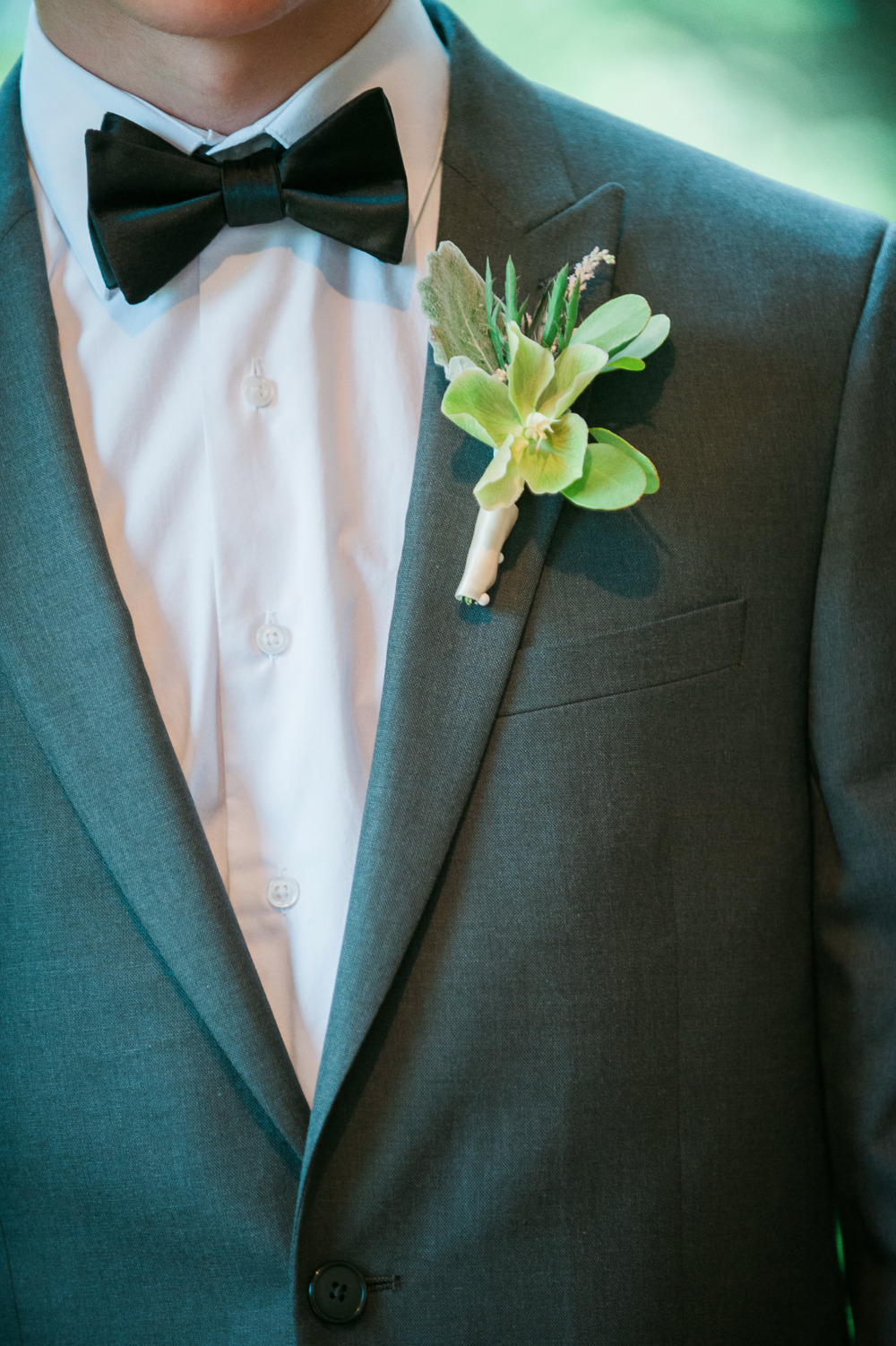 classic groomsmen attire with greenery boutonniere