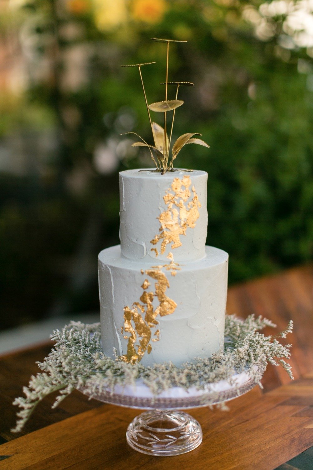 White and gold foil cake with gold metal topper