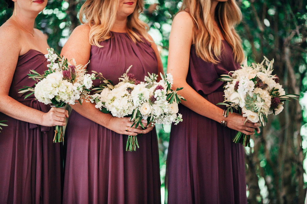 purple bridesmaid dresses with white bouquets