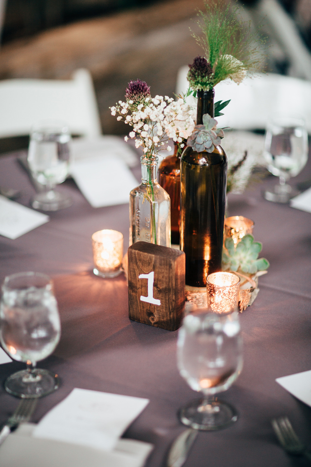 vintage bottle centerpiece with wood table number