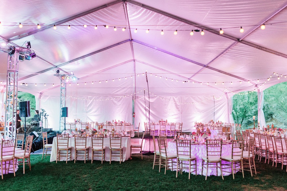 Pink tent reception with string lights