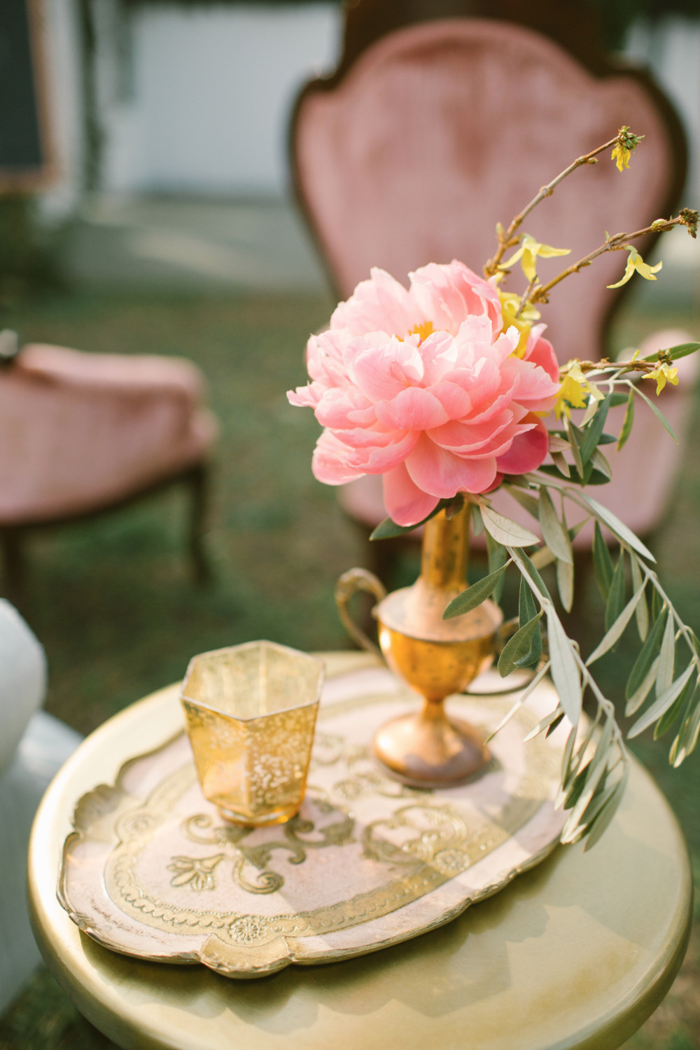 Pink peony arrangement on a golden table with vintage decor