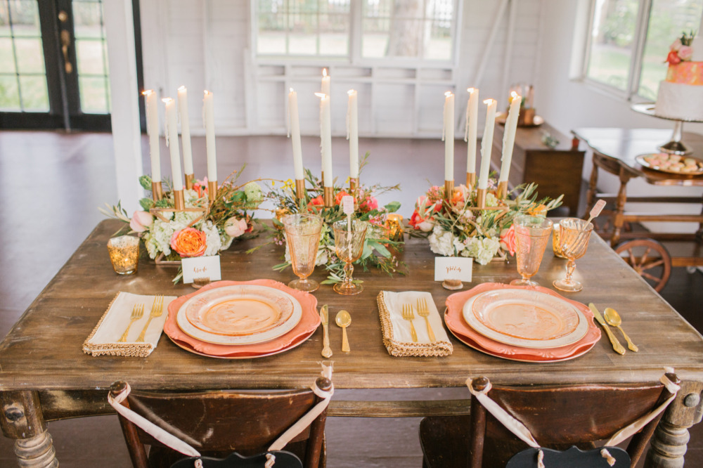 Rustic wedding table setting with peach plates and candles
