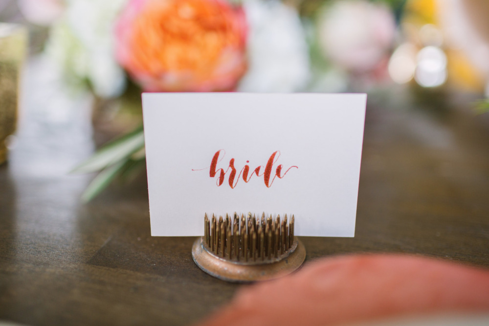 Bride place card with calligraphy at wedding reception
