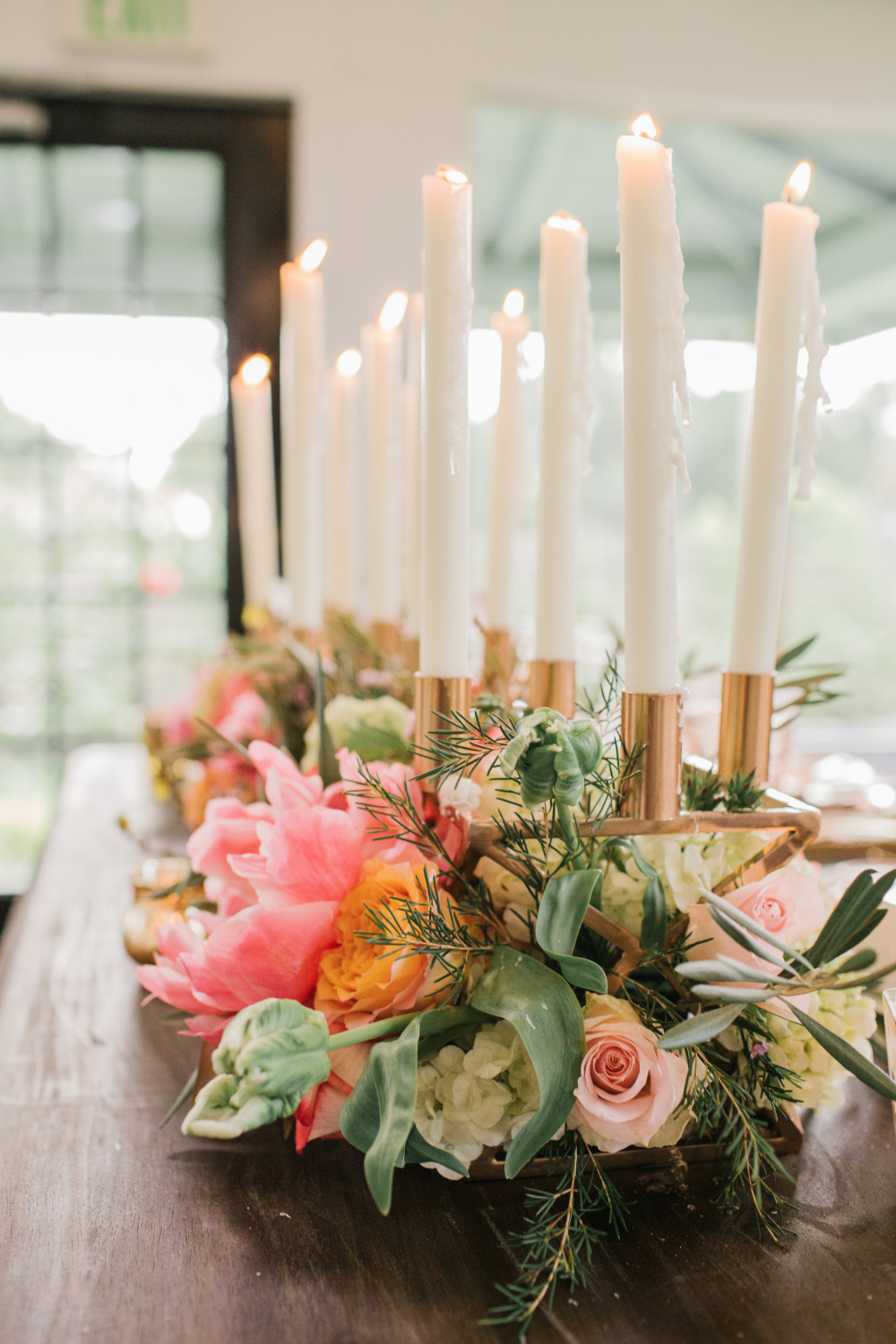 Elegant floral centerpiece with candles on table