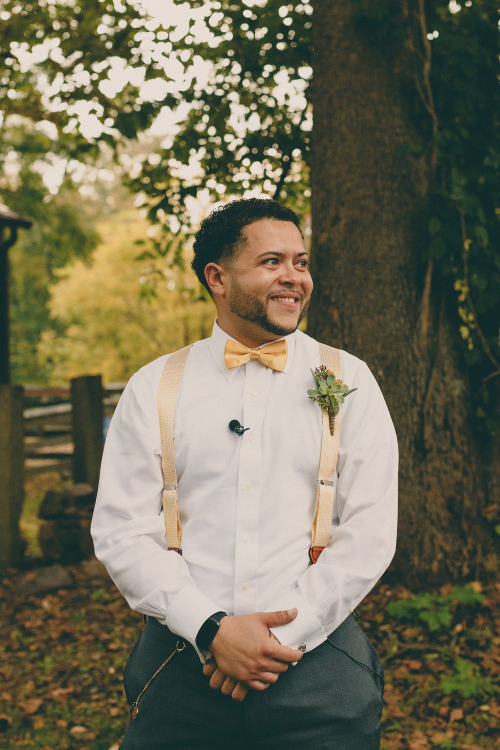 groom in suspenders and bow tie