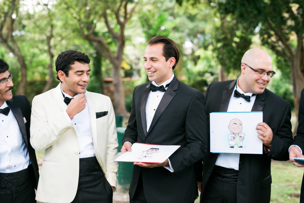 Groomsmen share caricatures before the wedding ceremony