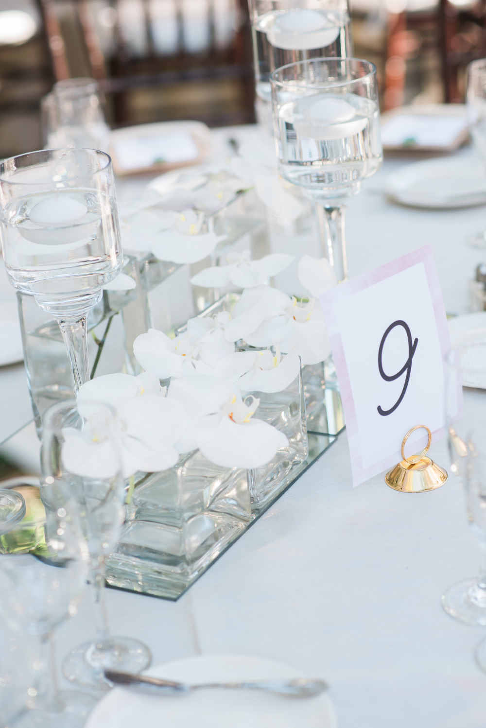 Elegant wedding table setting with orchids and number nine