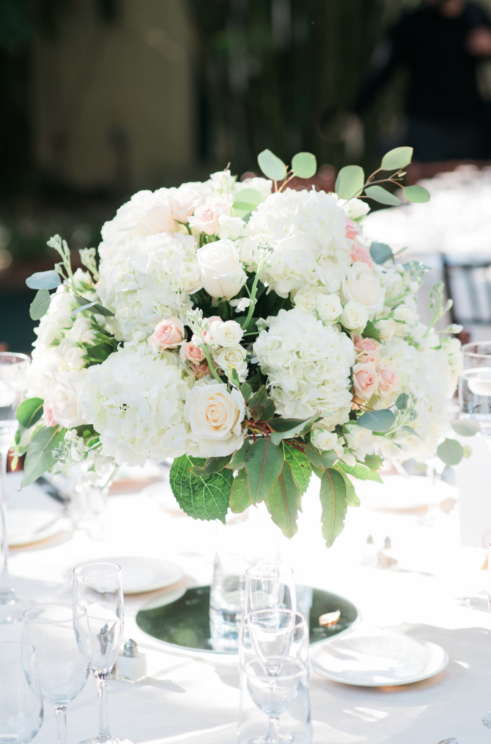 Elegant wedding centerpiece of white flowers roses