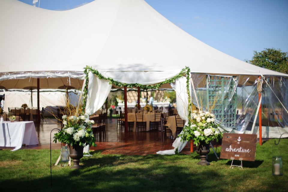 flower accented tent wedding reception entrance