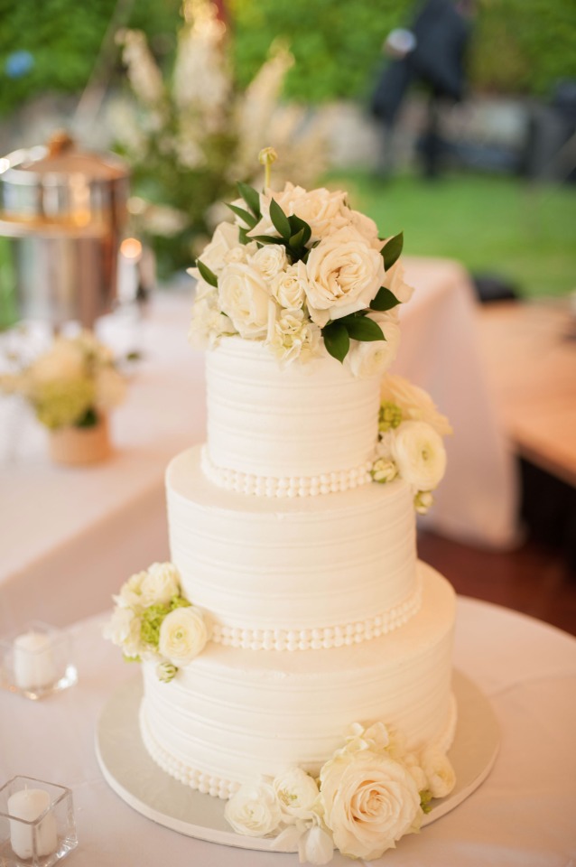 all white flower topped wedding cake
