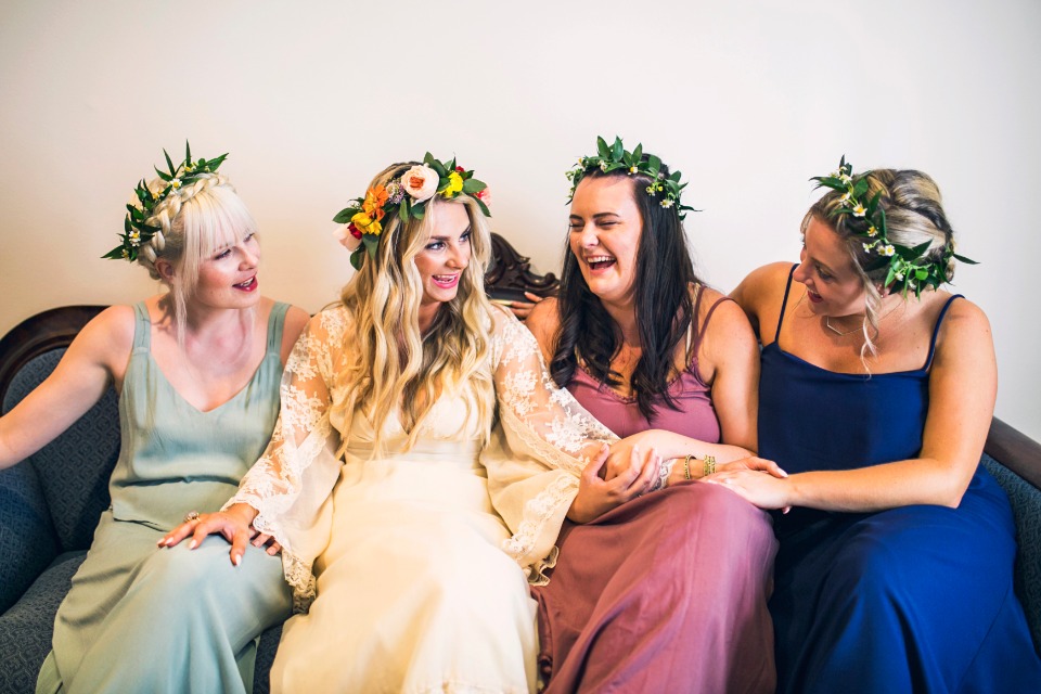 bridesmaids in mismatched dresses and flower halos