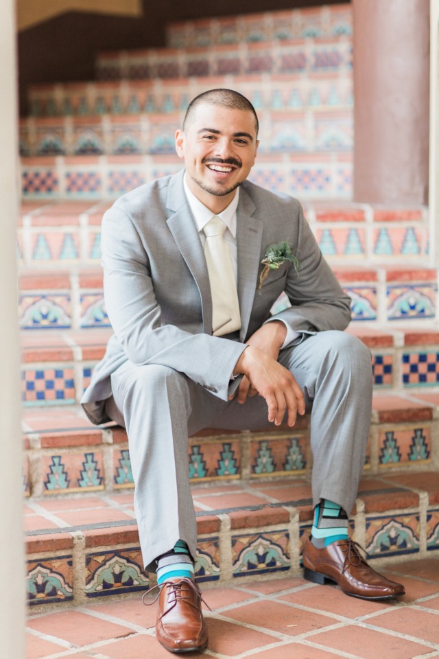 dapper groom in grey and ivory with funky socks
