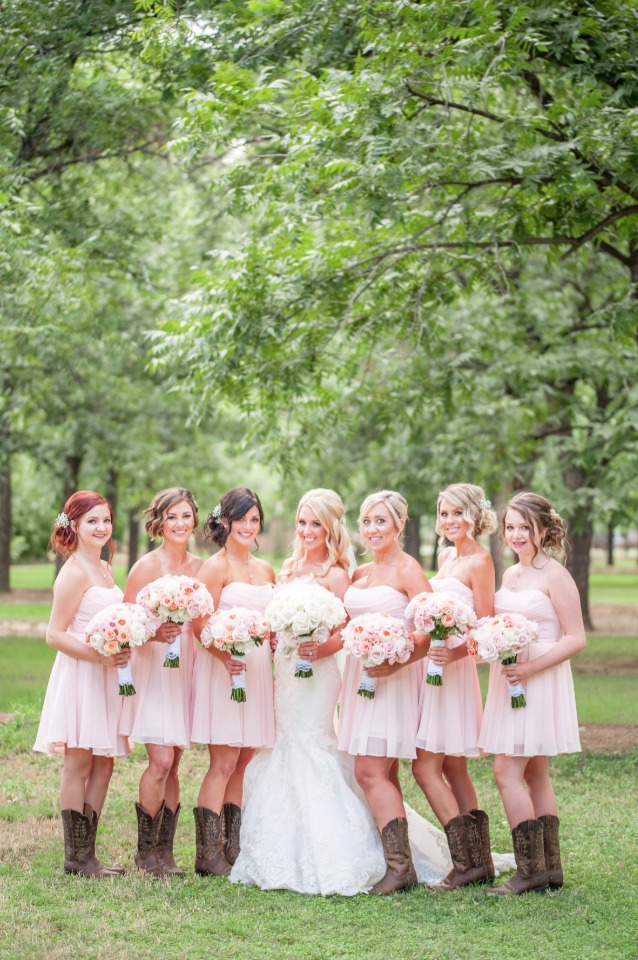 bridesmaids in knee length pink dresses and boots