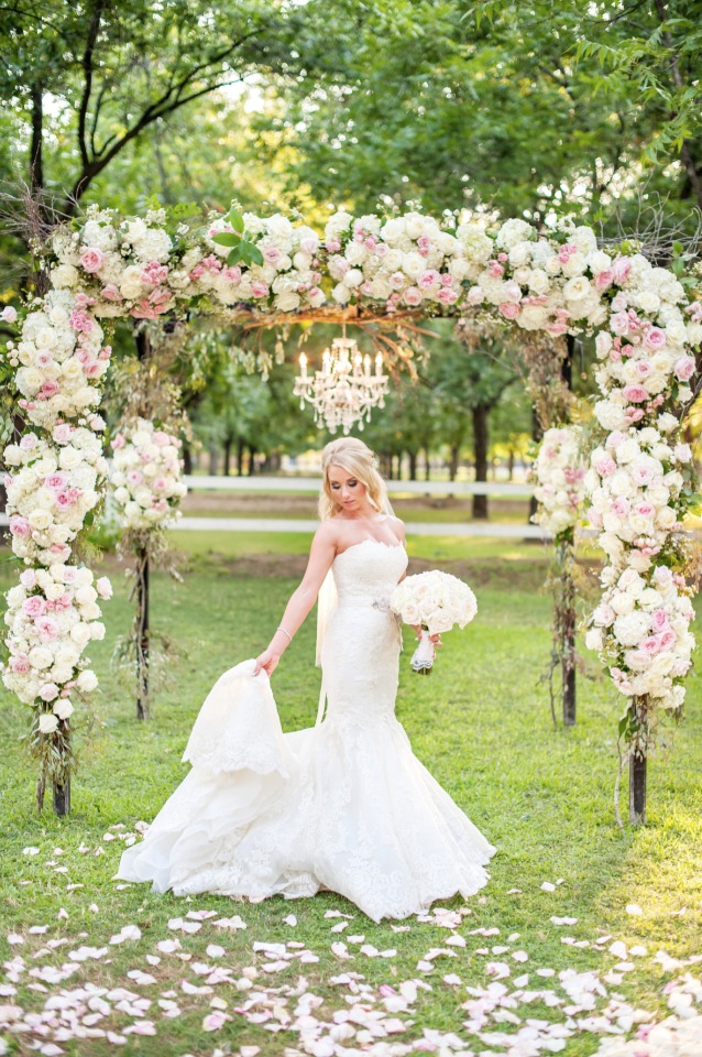 glamorous bride under a glam ceremony arch