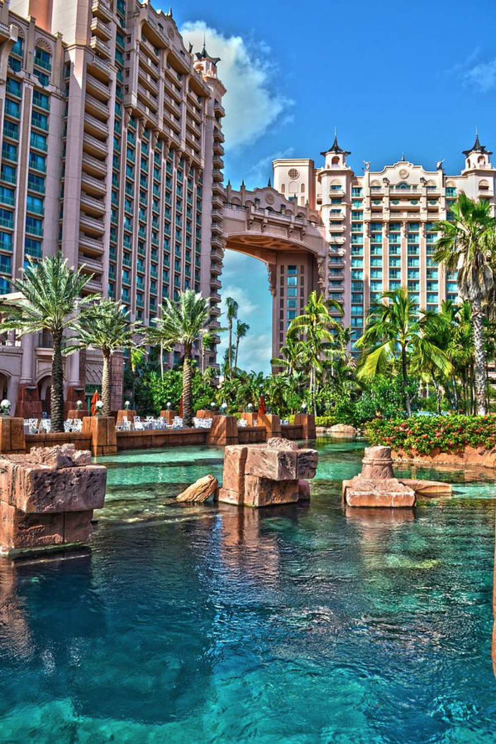 Luxury resort pool with Mayan ruins and tropical landscaping
