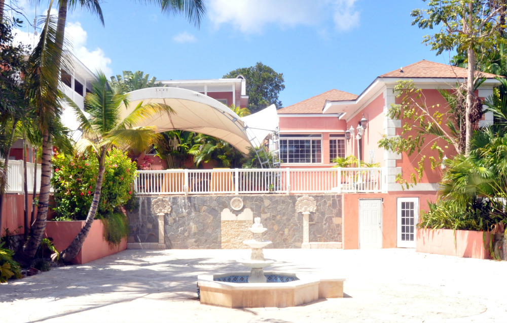 Tropical resort courtyard with fountain and shade structure