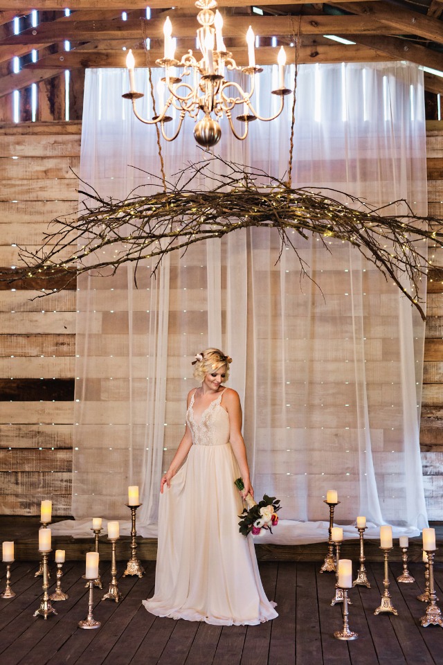 rustic chandelier and candle lit wedding decor